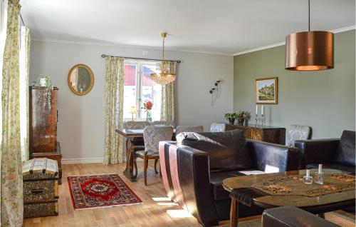 a living room with a couch and a table at Beautiful Home In Strängnäs With Sauna in Strängnäs