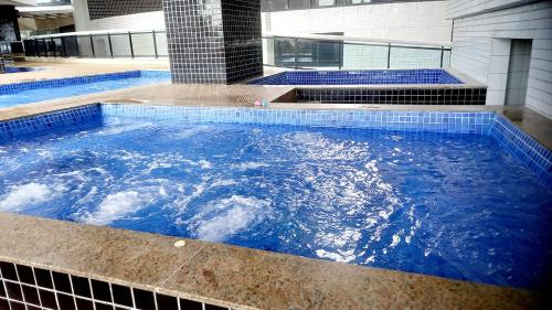 a large pool of blue water in a building at Landscape Beira Mar Fortaleza in Fortaleza