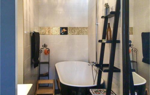 a bathroom with a bath tub and a ladder in it at Cozy Home In Skutskär With Sauna in Skutskär