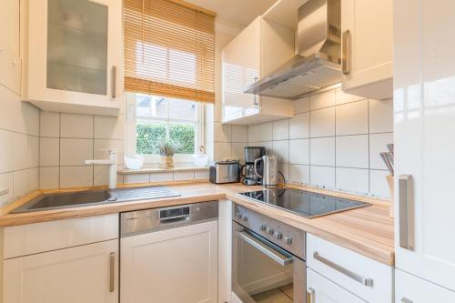 a kitchen with a sink and a stove at Ferienhaus Josephin in Boltenhagen