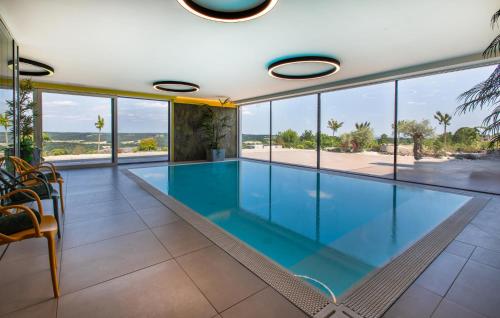 a swimming pool in a house with glass walls at Beautiful Apartment In Rogasovci in Rogašovci