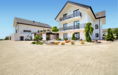 a large white building with a courtyard at Stunning Apartment In Rogasovci in Rogašovci