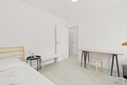 a bedroom with a bed and a table and chairs at Gîte Lasauvage 83 in Differdange