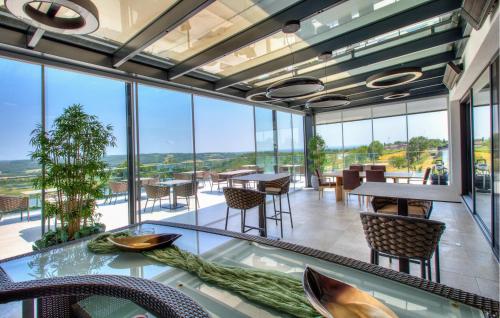 a large room with tables and chairs and windows at Amazing Apartment In Rogasovci in Rogašovci