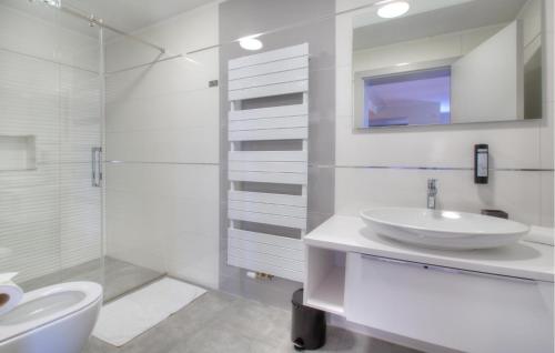 a white bathroom with a sink and a shower at Amazing Apartment In Rogasovci in Rogašovci