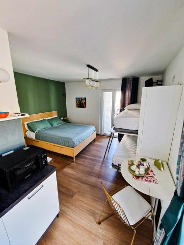 a small room with two beds and a table at Dimora Odigitria in Bitritto
