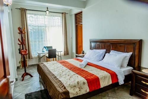 a bedroom with a large bed and a window at Bellevie Homestays in Uru