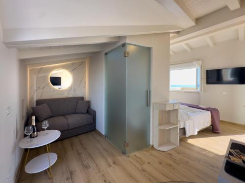 a living room with a couch and a bed at Junior Suite Hotel Biagi in Lido di Camaiore