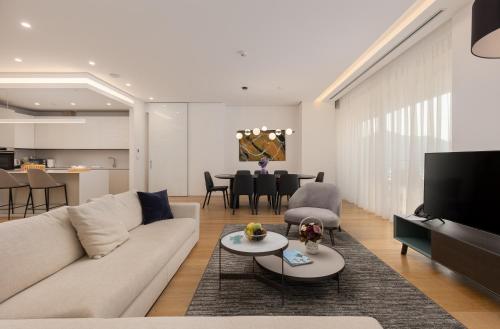 a living room with a couch and a table at Dukley Hotel & Resort in Budva