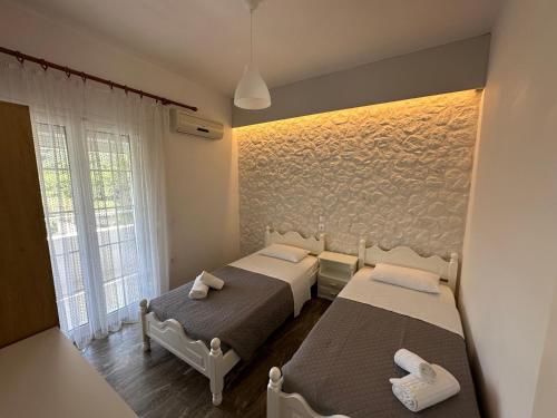 a room with two beds and a window at Vista Verde Apartments in Sidari