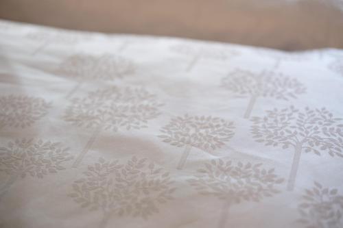 a white bedsheet with drawings of trees on it at New Residence Schnatzhof Schlanders in Silandro