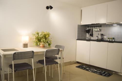 a kitchen with a table and chairs in a room at Woodstock IX, self check-in in Riga
