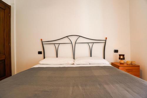 a bedroom with a bed with a metal headboard at Il Cuore del Lago in Lazise