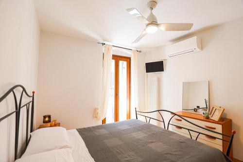 a bedroom with a bed with a ceiling fan at Il Cuore del Lago in Lazise