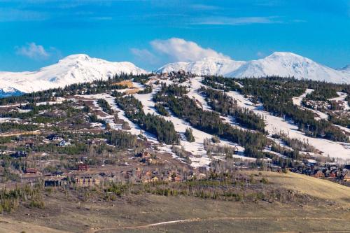 a mountain with snow capped mountains in the distance at Summit Unit 1303 in Granby