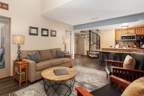 a living room with a couch and a table at Summit Unit 1303 in Granby