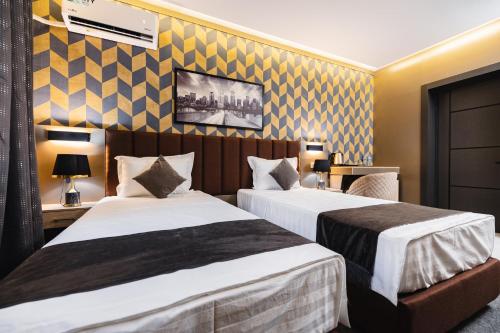 a hotel room with two beds in a room at Art Air Hotel in Tashkent