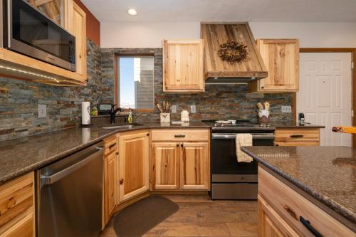 a kitchen with wooden cabinets and black appliances at Mountainside Unit B-20 in Granby