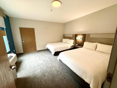 a hotel room with two beds and a bathroom at Holiday Inn Express Hotel & Suites North Sequim by IHG in Sequim