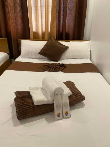 a hotel room with two beds with towels on them at The Birrells Boracay by Cassy in Boracay