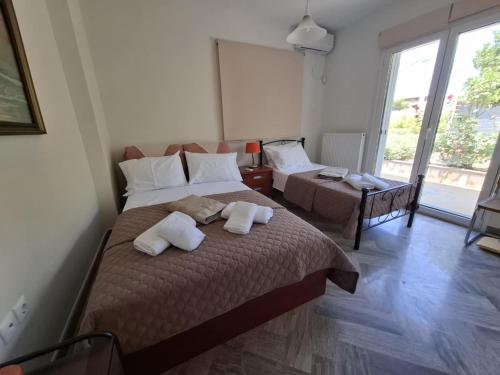 a bedroom with two beds with towels on them at Bella Vista pool Villas in Anavissos in Barbaliáki