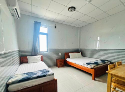 Postel nebo postele na pokoji v ubytování Hotel Sen Việt Bạc Liêu