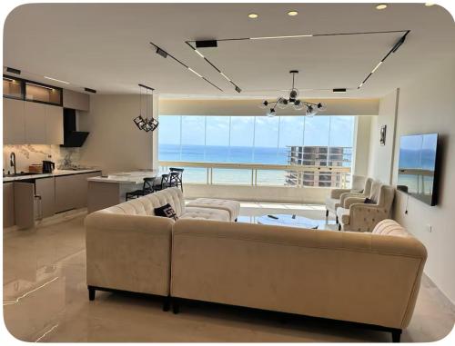 ein Wohnzimmer mit Sofas und Meerblick in der Unterkunft Water Front Luxury in Jnah Beirut 