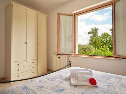 a bedroom with a bed and a large window at Casa Vacanze Santa Caterina in Asciano