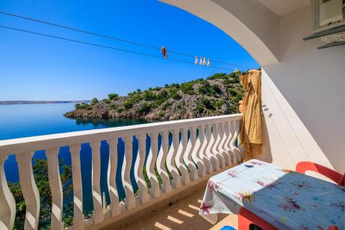 a room with a balcony with a view of the ocean at Apartments Tasa in Lukovo Šugarje