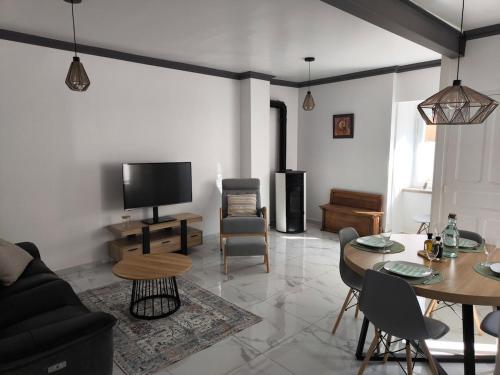 a living room with a couch and a table at Maison au coeur de Banon in Banon
