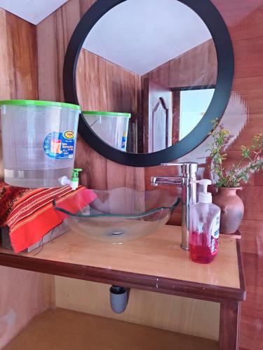 a bathroom counter with a sink and a mirror at TITIKAKA chakana lodge in Puno