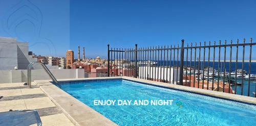 a swimming pool on the roof of a building at Marina Bay Elegance Room Balcony Overlooking Luxury Yachts in Hurghada