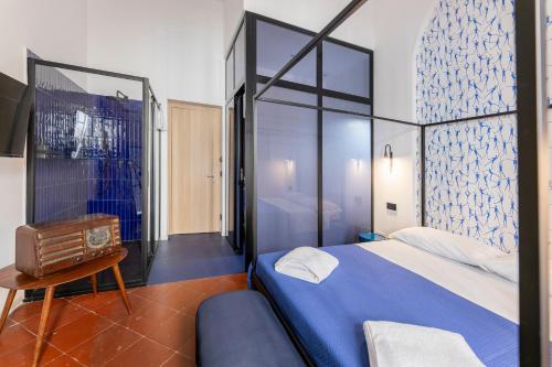 a bedroom with a large bed and a glass wall at Assoli House in Naples