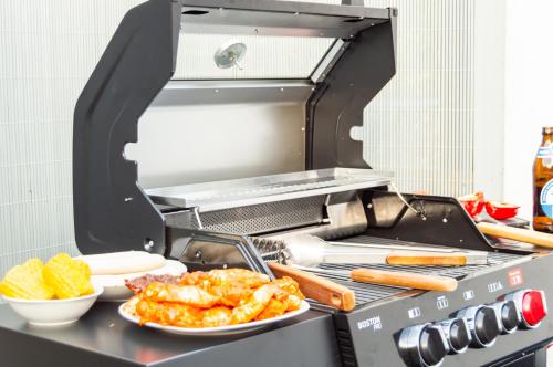 a barbecue grill with two plates of food on it at Ferienwohnung Wellnessblick - Nähe Triberger Wasserfälle in Triberg