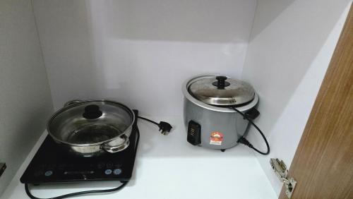 a kitchen counter with a toaster and a pot at Alanis Suite KLIA With Neflix in Sepang