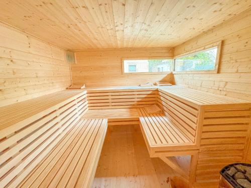 a sauna with wooden benches in a wooden room at Ferienwohnung Wellnessblick - Nähe Triberger Wasserfälle in Triberg