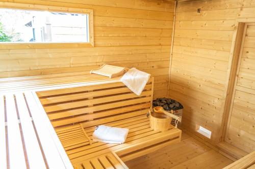 a wooden sauna with a bench and books in it at Ferienwohnung Wellnessblick - Nähe Triberger Wasserfälle in Triberg