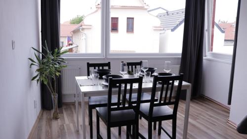 a dining room with a table and chairs and a window at MIRA apartments in Prague