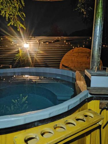 a hot tub in a backyard at night at Lodge Rincon Nativo in Hijuelas