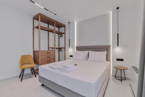 a bedroom with a white bed and a chair at PREVEZA VILLA center in Preveza