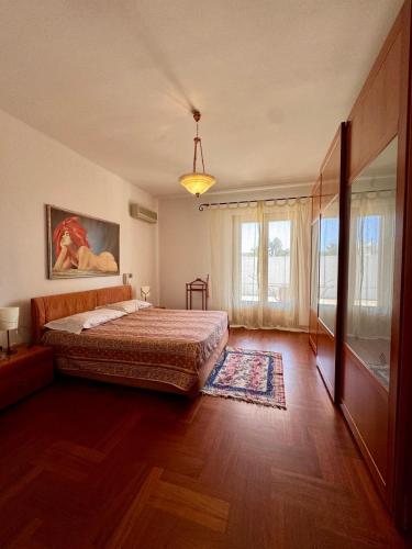 a bedroom with a bed and a large window at Villa Erika in Gallipoli