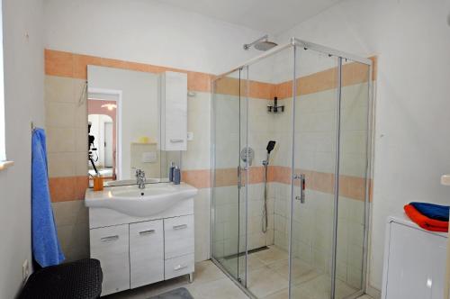 a bathroom with a sink and a shower at HOLIDAY's HOUSE in Semedela
