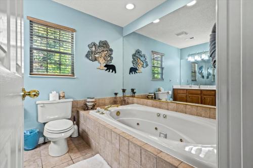 a bathroom with a tub and a toilet and a sink at Mountains 4 Miles By Avada Properties in Gatlinburg