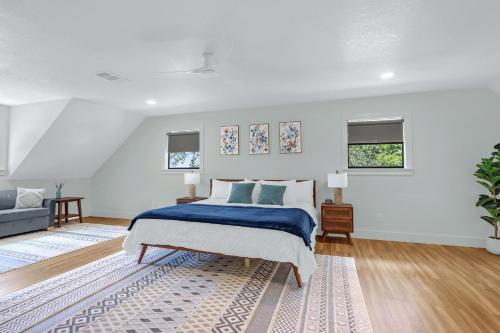 a white bedroom with a bed and a couch at Jalsa in Wimberley