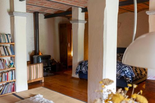 a living room with a bed and a fireplace at Cá Pradella - Harmony and Nature, Bed & Breakfast in Monterenzio