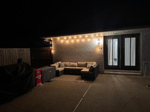 a living room with a couch and a brick wall with lights at 4BR Ocean Springs Home with Luxury Amenities in Ocean Springs