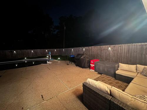 a patio with a couch and a fence at night at 4BR Ocean Springs Home with Luxury Amenities in Ocean Springs