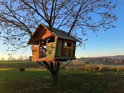 a tree house in a tree in a field at Usedlost Horka Onšov in Onšov