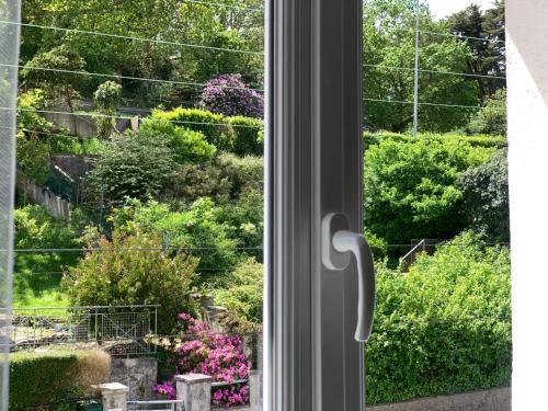 a window with a view of a garden at Villa Auguste chambres d'hôtes in Quimper