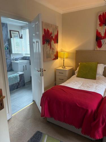 a bedroom with a bed and a bathroom at Gwynarth Guest House in Wadebridge